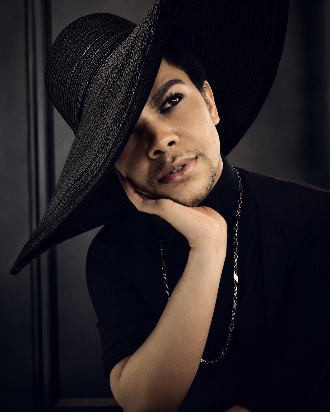 Jaylen Jaymes wearing a dramatic sculptural black hat